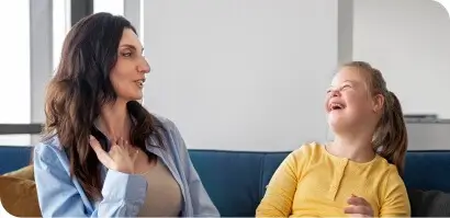NDIS participant with a carer, laughing together - NDIS cleaning services