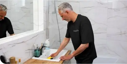 Simply Spotless cleaner cleaning a bathroom sink during a domestic cleaning service